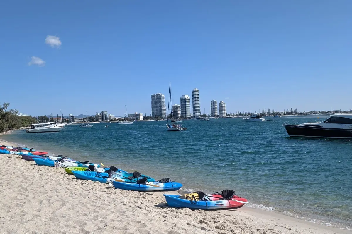 Kayaks en la playa del Broadwater con los edificios de Gold Coast al fondo
