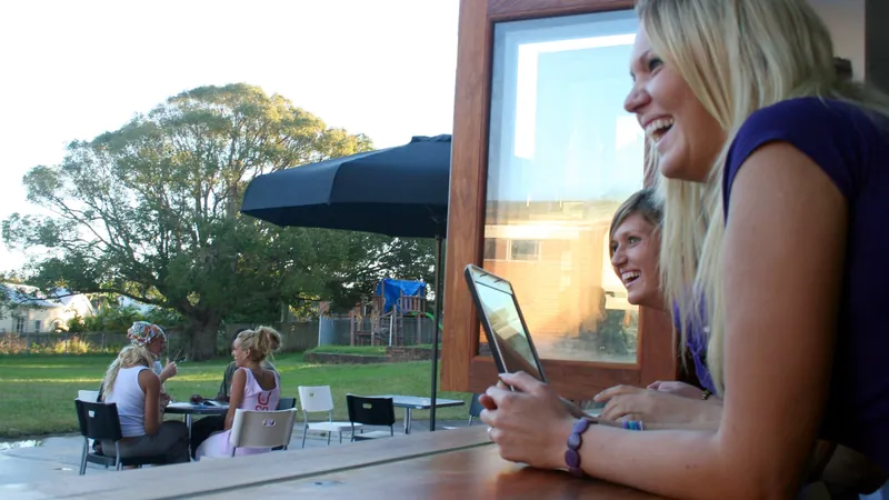 Estudiantes sonrientes en la terraza de Lexis Byron Bay